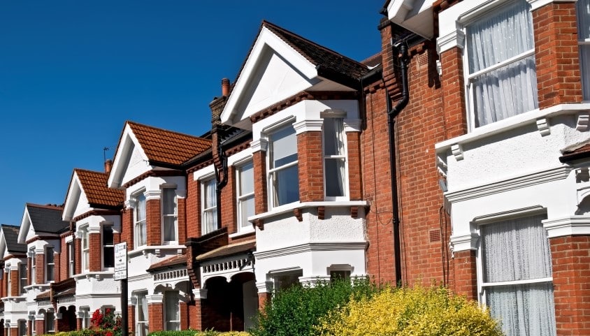 A row of terraced red brick housing in the UK