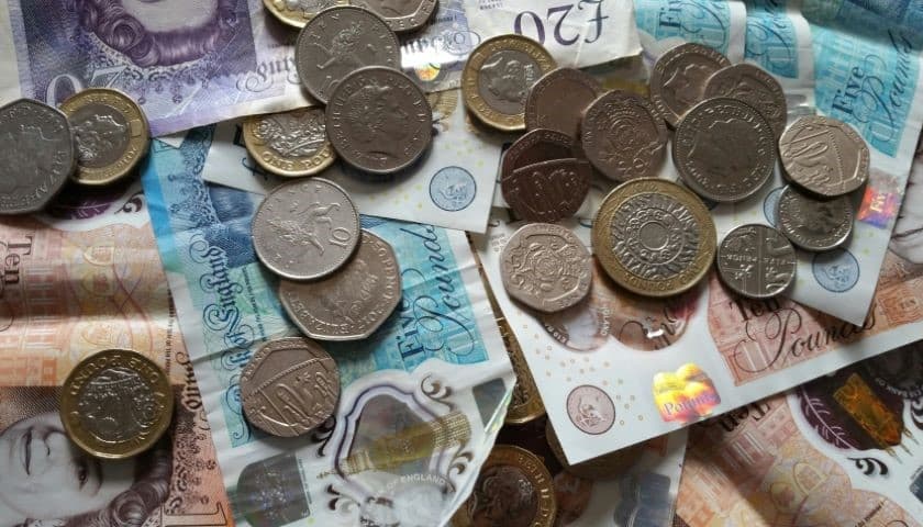 A close up of UK money including coins and notes